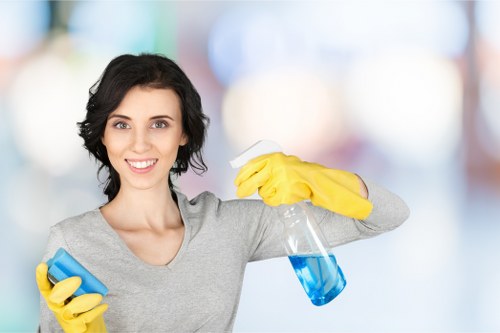 Domestic cleaner tidying a period property in London