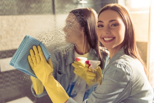 Cleaner maintaining a tidy and hazard-free flat cleaning workspace